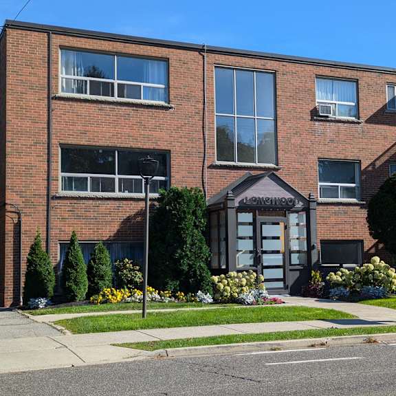 a brick building with a small entrance and a sign that says "entrance".