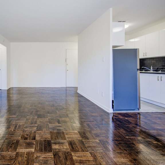 a room with a wooden floor and a blue door.