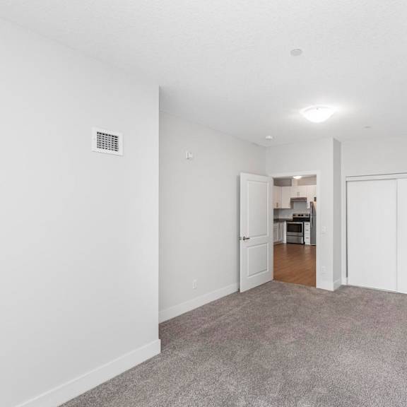 a room with a carpeted floor and a white door.