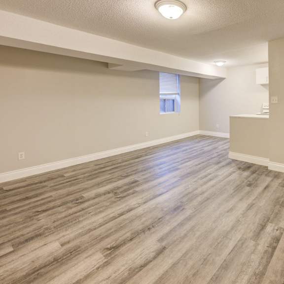 a room with wooden flooring and a window.