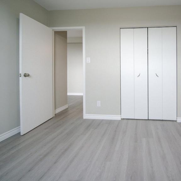 a room with a white door and a white wardrobe.
