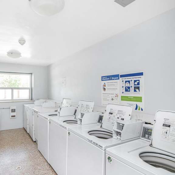 a laundry room with washers and dryers.