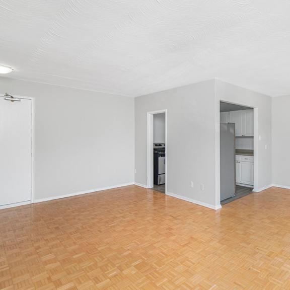 a room with a wooden floor and white walls.