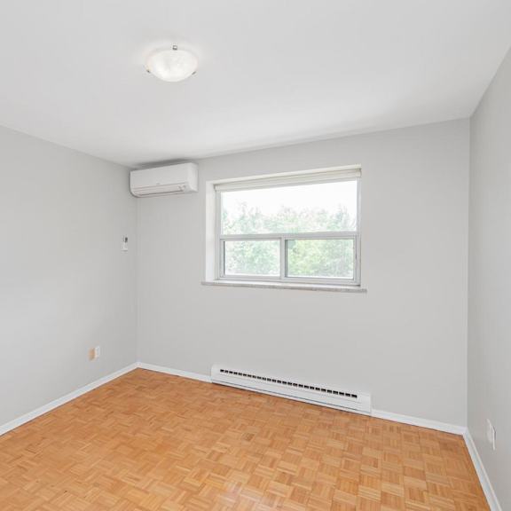 a room with a window and a radiator on the floor.