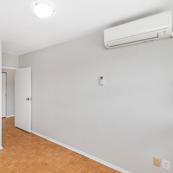 a room with a white wall and a white door with a white cabinet.