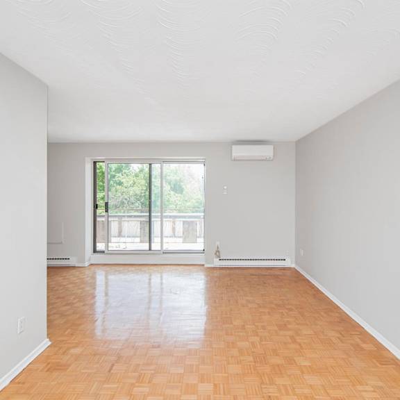 a room with wooden flooring and a window.