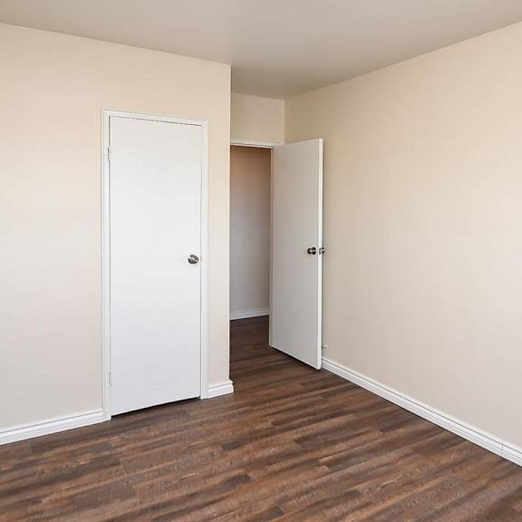a room with a white door and a white cupboard.