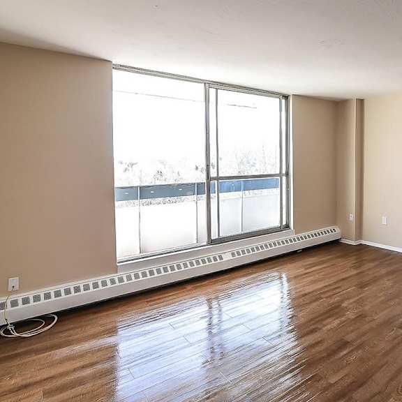 a room with a window and a radiator on the floor.