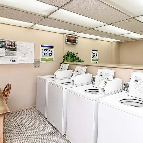 a row of washing machines in a laundromat.