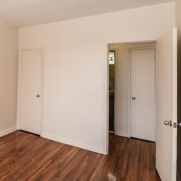 a room with two doors and a wooden floor.