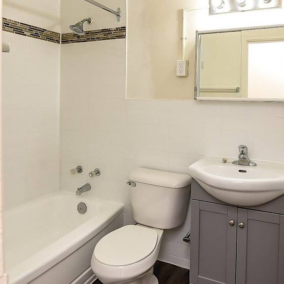a white toilet sits next to a sink in a small bathroom.