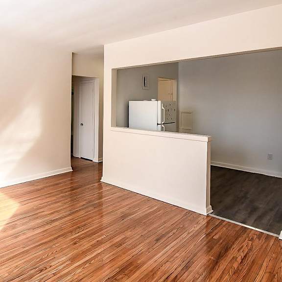 a room with wooden floors and white walls.