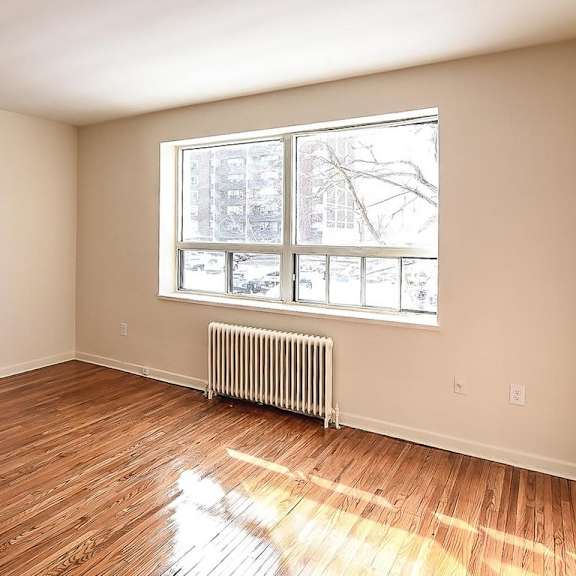 a room with a window and a radiator on the floor.