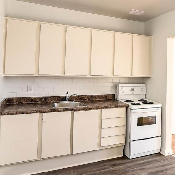 a kitchen with white appliances and cabinets.