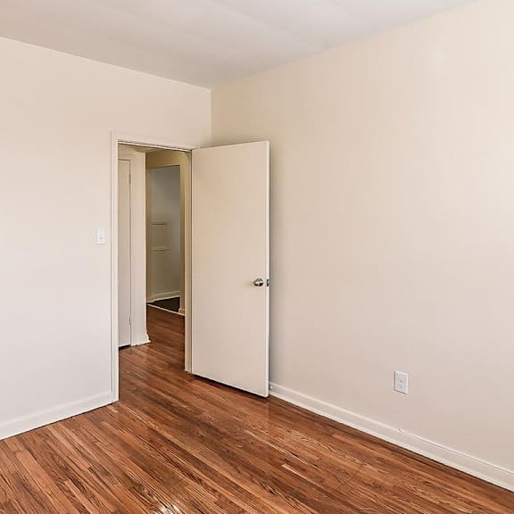 a room with a white door and a white closet door.