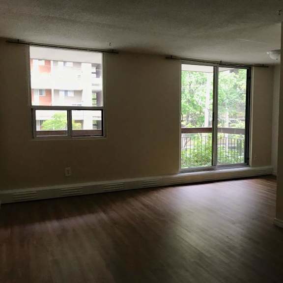 a room with a window and sliding glass doors.