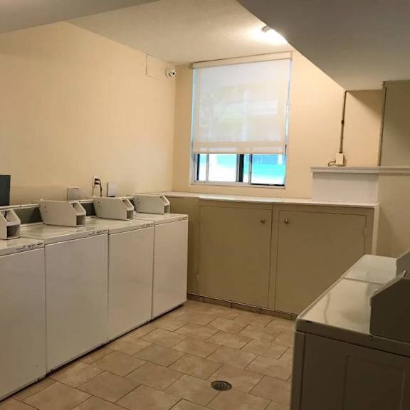 a row of washing machines in a laundromat.