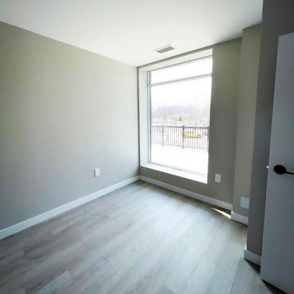 a room with a grey floor and a white door.