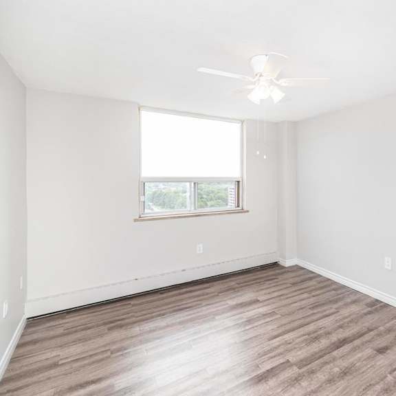 a room with a ceiling fan and a window.