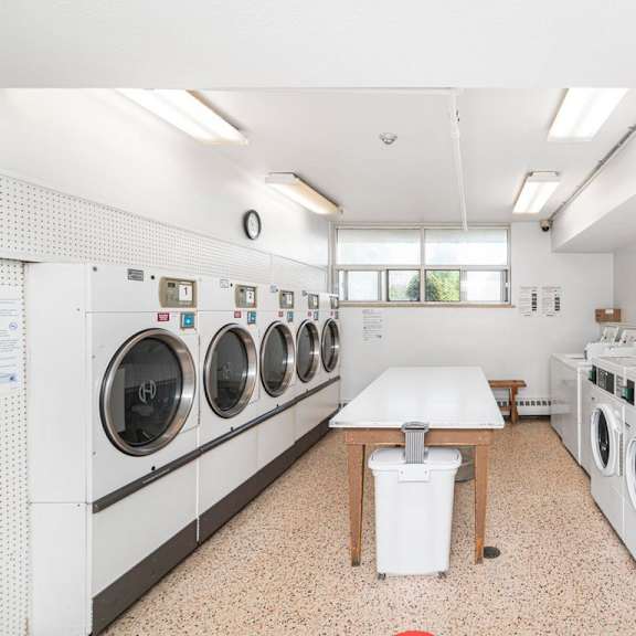 a laundromat with a row of washers and dryers.