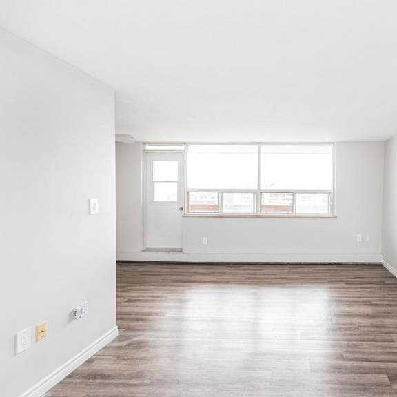 a room with a wooden floor and a window.