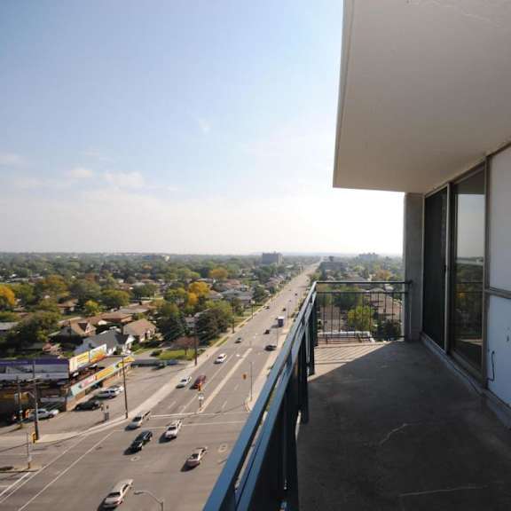 a view from a building looking out over a highway with cars on it.