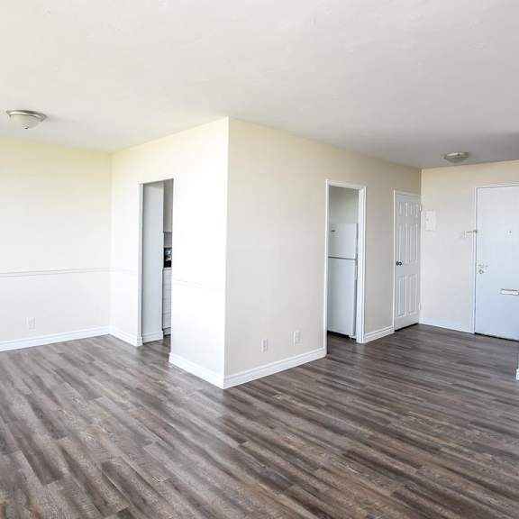 a room with wooden floors and white walls.