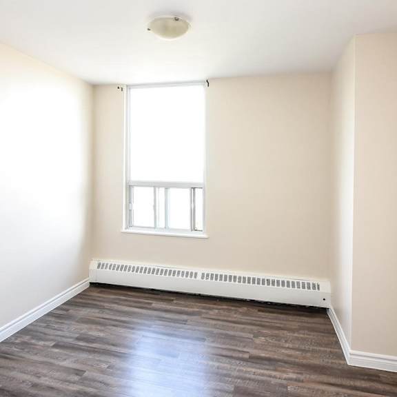 a room with a window and a radiator on the floor.
