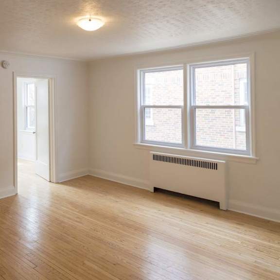 a room with a white wall and a window with a white frame.