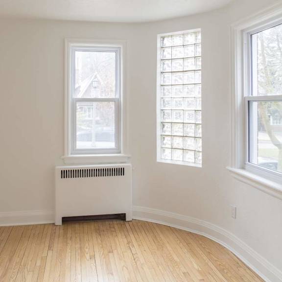 a room with a window and a radiator on the floor.