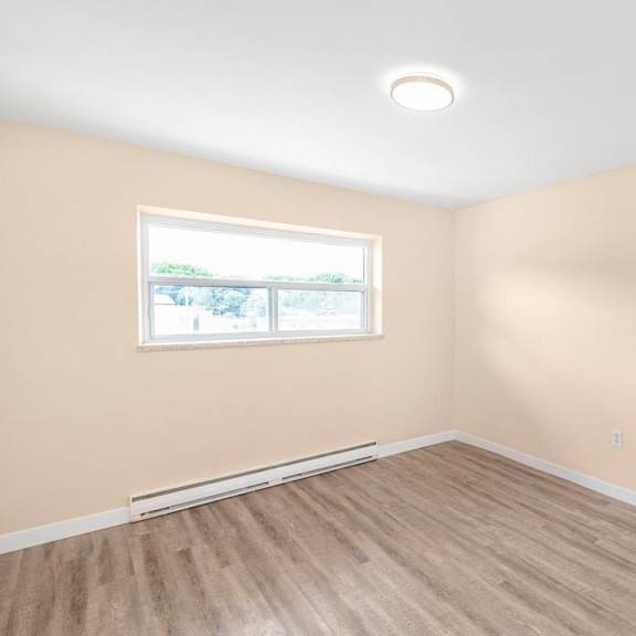 a room with a window and a white ceiling.