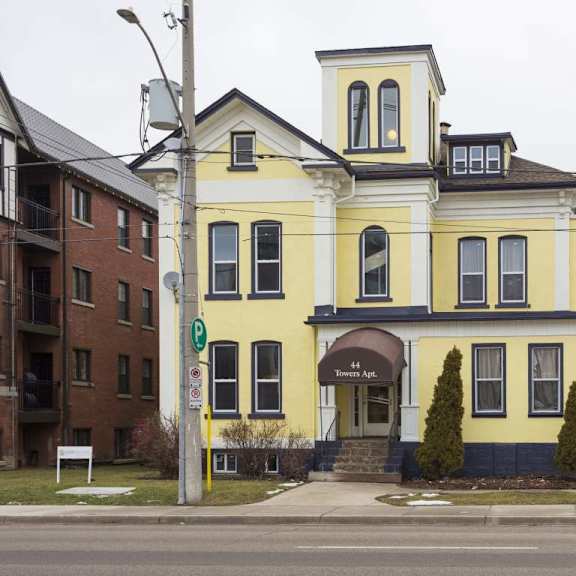 a yellow building with a black roof and a sign that says "the apk" on it.