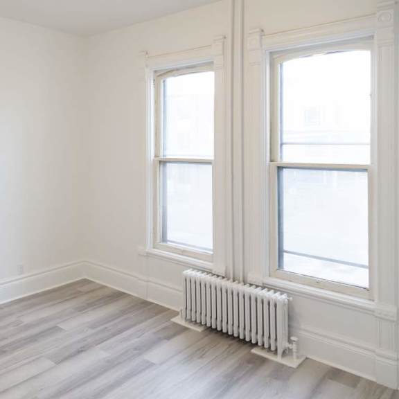 a room with a white wall and a window with a white frame.