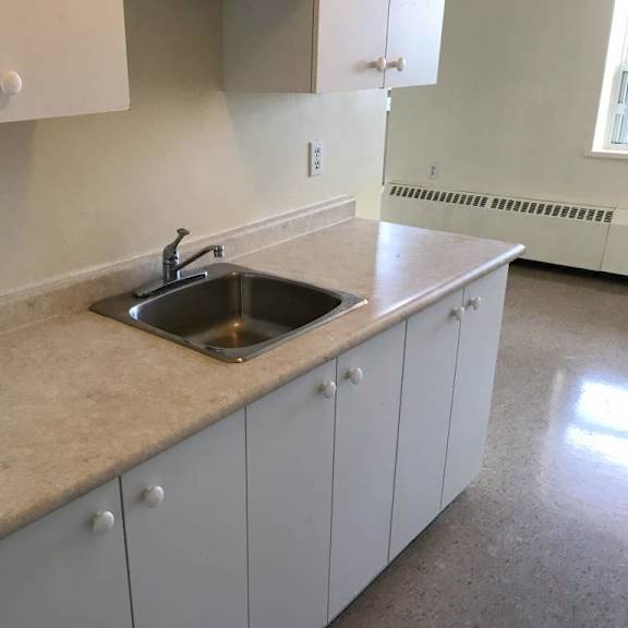 a kitchen with a sink and cabinets.