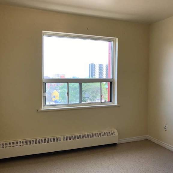 a room with a window and a radiator on the floor.