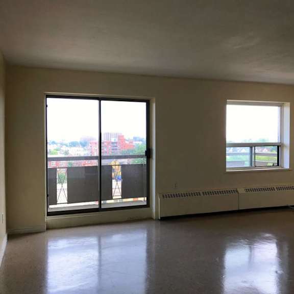 a room with a large window and a balcony.