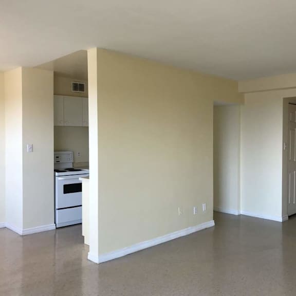 a room with a white oven and a white dishwasher.