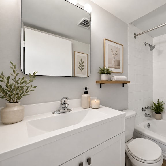 a white bathroom with a sink, toilet, and bathtub.