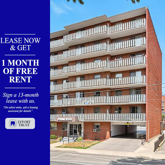 a large brick building with a sign offering a free month of rent.