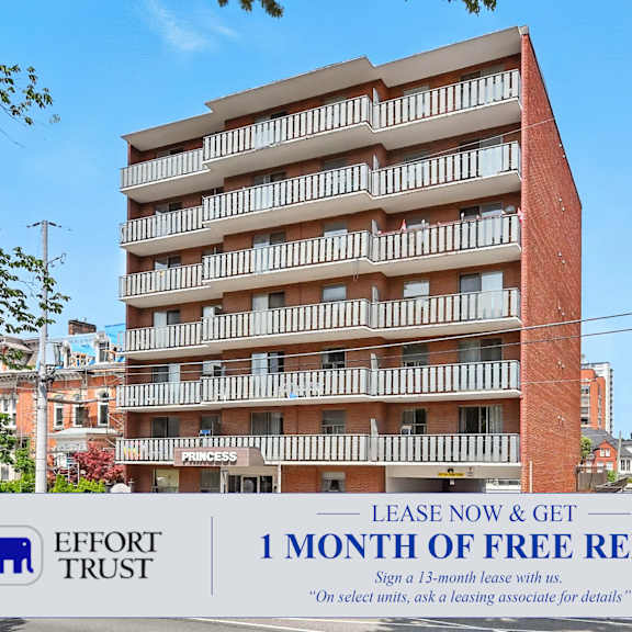a large building with a sign offering a free month of rent.