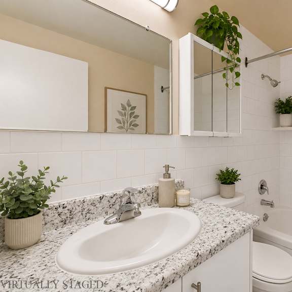 a bathroom with a white sink and a white toilet.