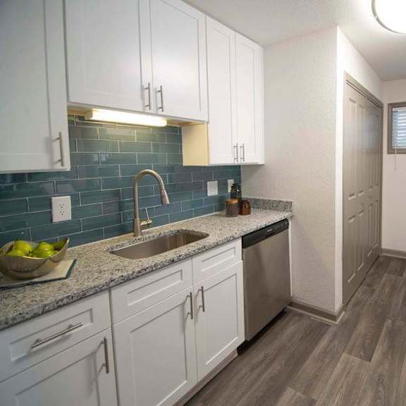 a kitchen with white cabinets and a black stove top oven. at paces ridge at vinings, georgia
