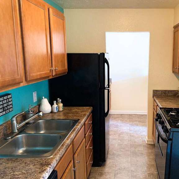 a kitchen with a black refrigerator and stove. at sienna ridge, georgia, 30345