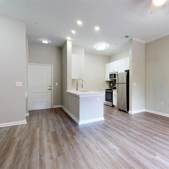 a kitchen area with a white countertop and wooden flooring. at vue at embry hills, atlanta, ga, 30042