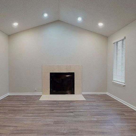 a room with a fireplace and wood flooring. at spalding vue, peachtree corners, 30092