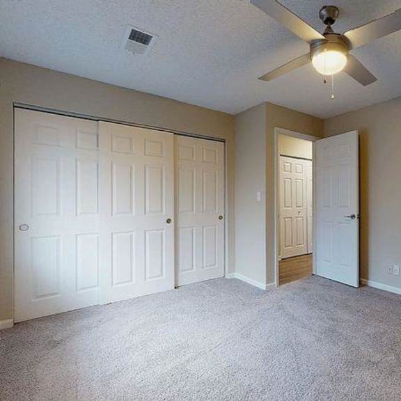 a room with a ceiling fan and carpeted floor. at spalding vue, peachtree corners, ga, 30092