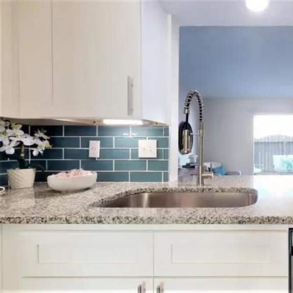 a kitchen with a stainless steel dishwasher and white cabinets. at cumberland pointe, georgia, 30080