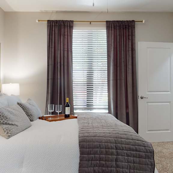 a bedroom with a large bed and a window with curtains at embry hills, atlanta, ga, 30042