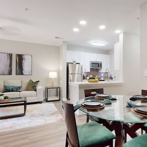 a modern dining room with a glass table and green chairs at embry hills, atlanta, ga