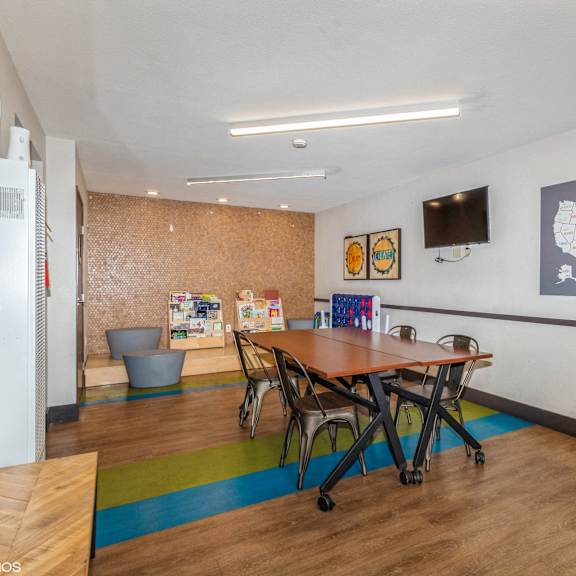 a room with a table and chairs and a map of the united states on the wall.